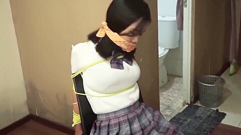 Schoolgirl bondage scene with rope restraints - free porn video